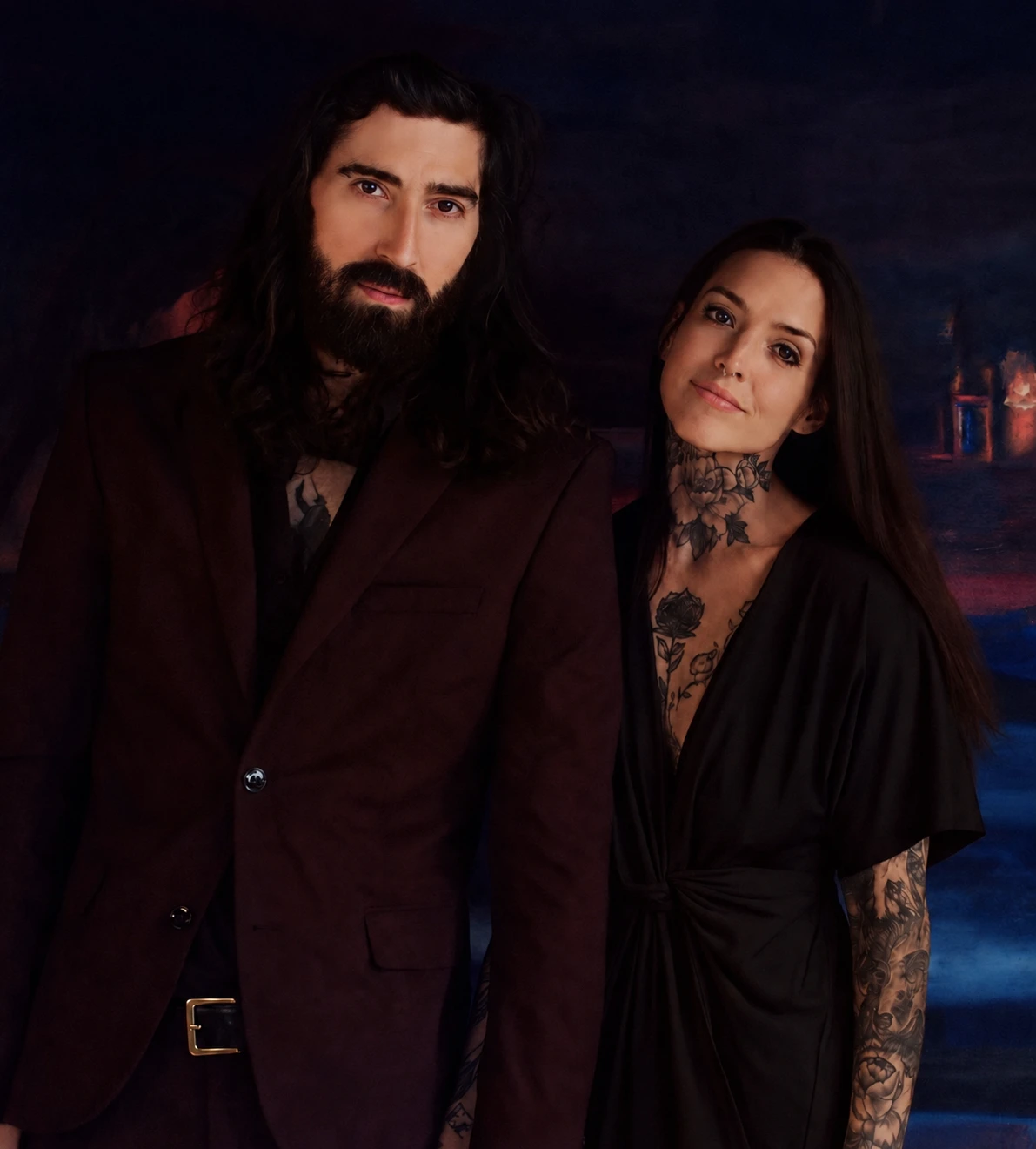Ty and Hope Cole, co-founders of Vigil Art House, standing together in a softly lit interior.