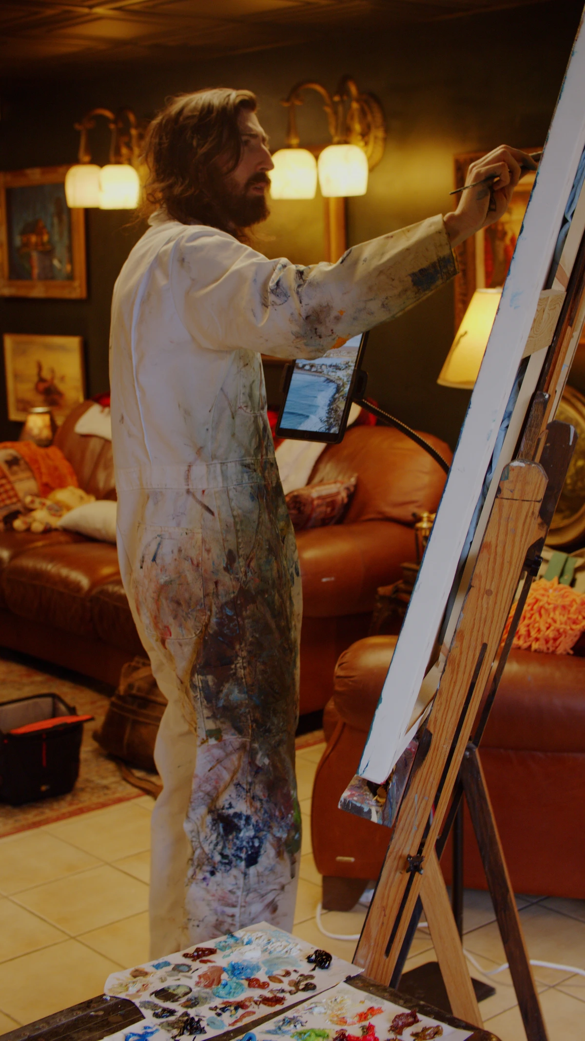 Ty Cole at work on a large oil painting in his studio.